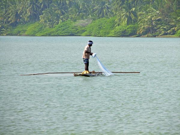 Fisherman in a log boat
