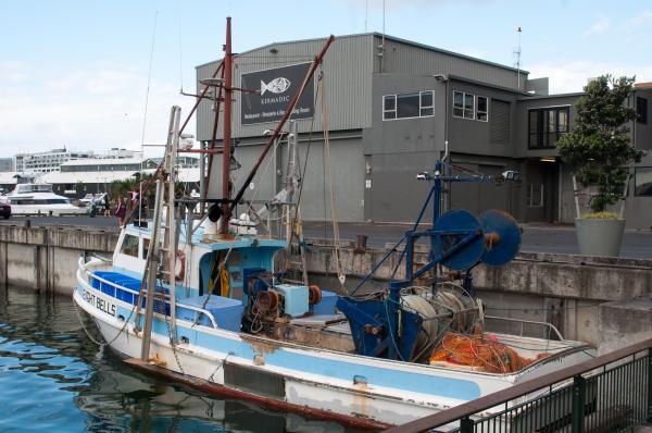 Fishing vessel in front of restaurant