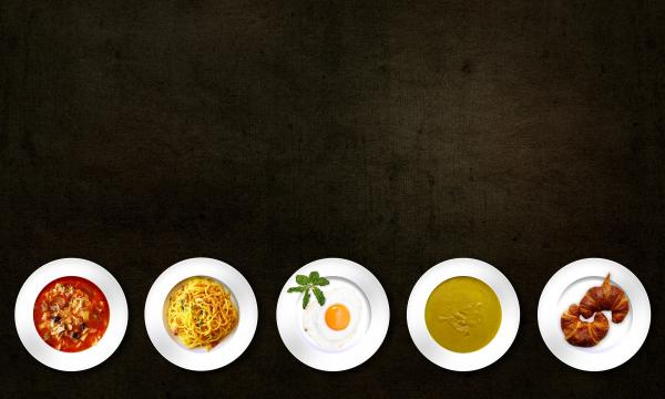 Five White Plates With Different Kinds of Dishes
