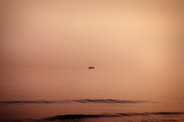 Floating - A lonely distant boat cruisin