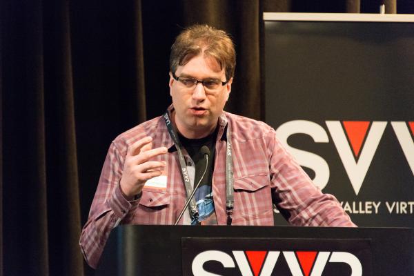 Frank Nora (developer of Nightstation, representing New York City VR Meet-Up) giving 60 Second Pitch at SVVR (one hand raised)