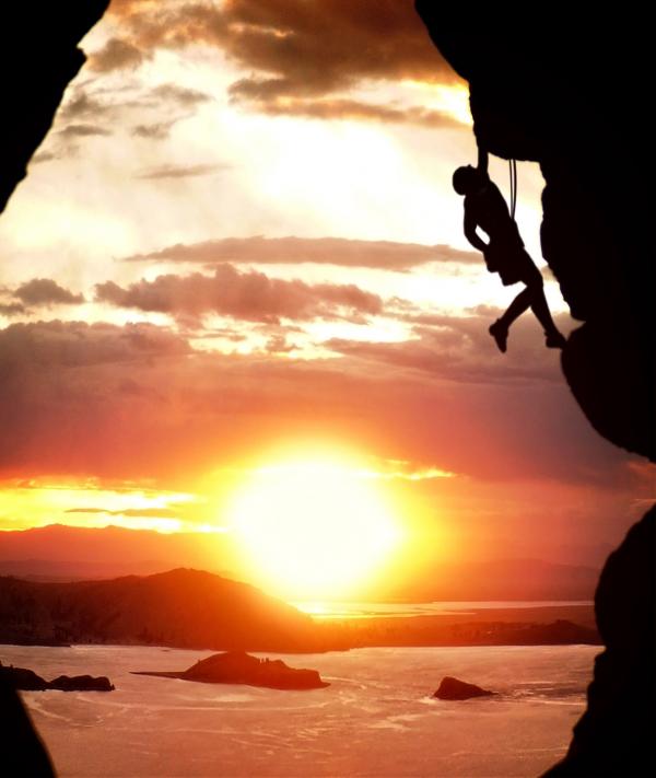 Free-climber rising at sundown