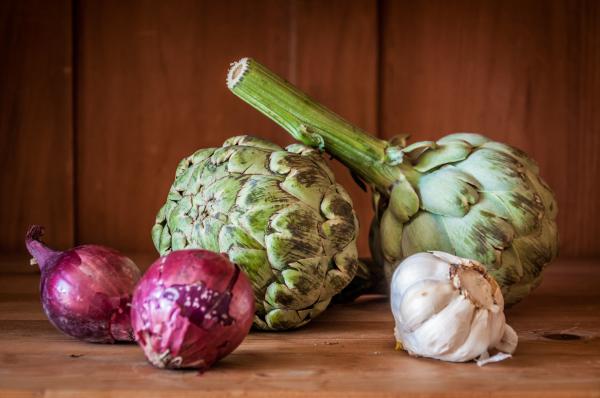 Fresh artichokes on rustic wood