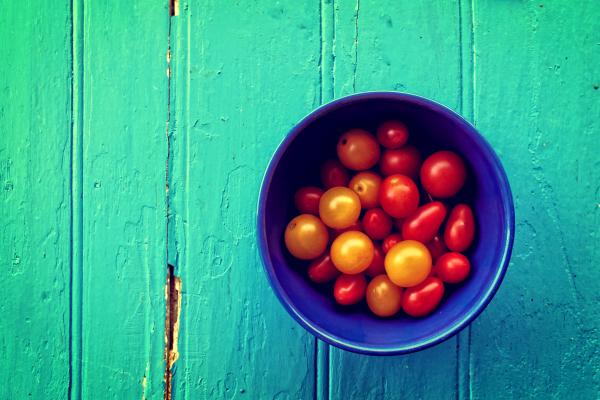 Fresh colorful cherry tomatoes on wood background - Organic farming