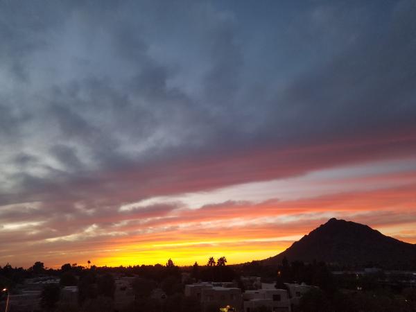 Gray and White Buildings and Brown Mountain during Dusk