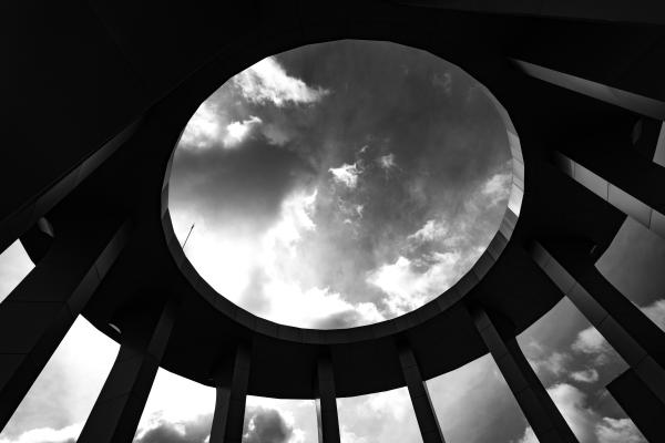 Grayscale Photo of a Round Building With Hole