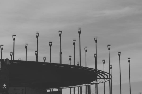 Grayscale Photo of Road Light Post Lot