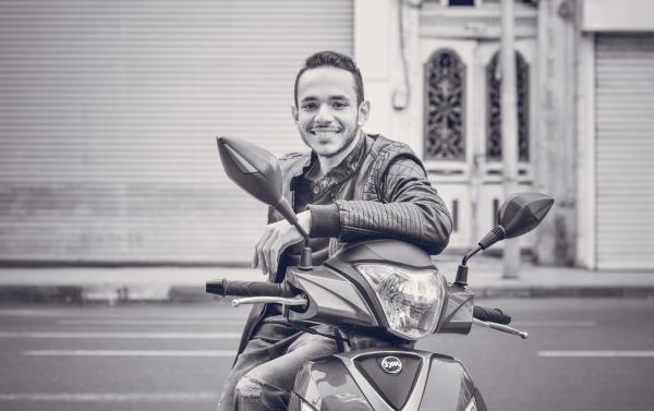 Grayscale Photography of Man Sitting on Motorcycle