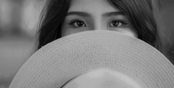 Grayscale Photography of Woman Covering Her Face With Sun Hat