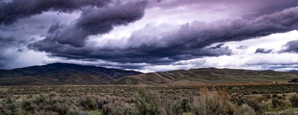 Great panorama of the blue sky, mountains on the horizon and fields