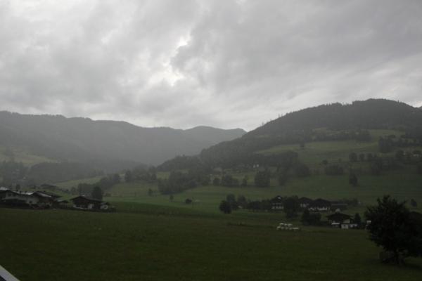Green hill covered with clouds