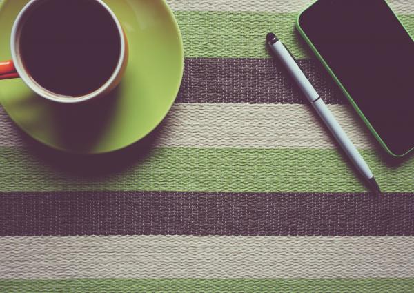 Green Iphone 5c Next to Coffee Mug