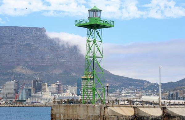Green lighthouse in unknown port