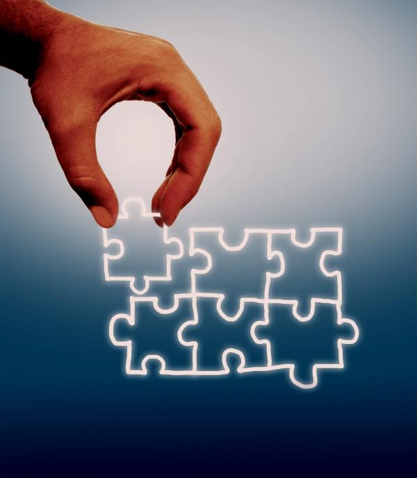 Hand assembling jigsaw on virtual screen