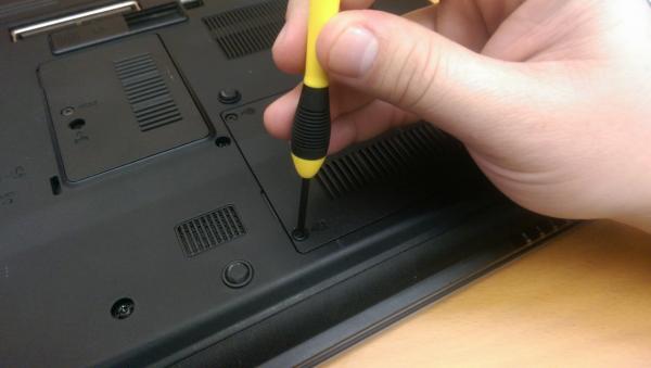 Hand holding a laptop screwdriver