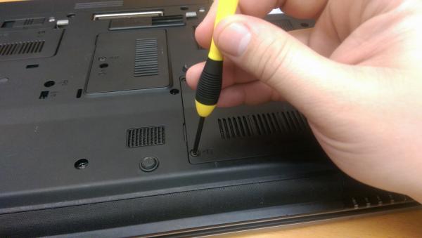 Hand holding a laptop screwdriver