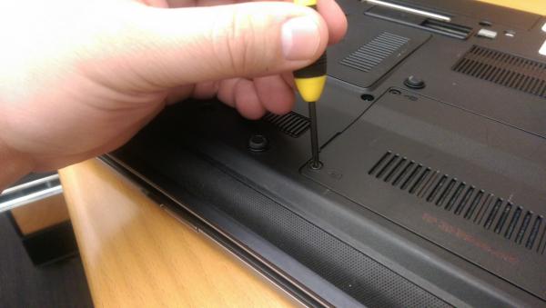 Hand holding a laptop screwdriver