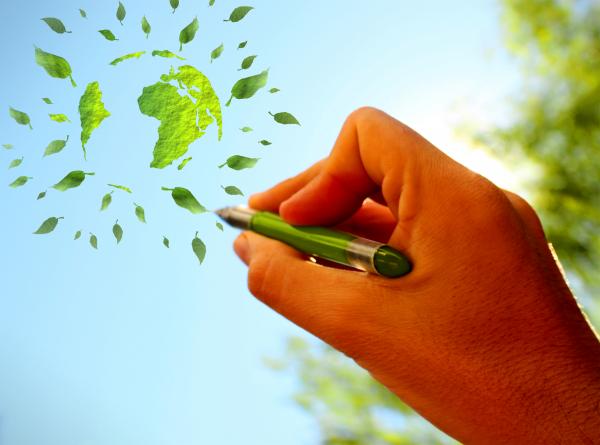 Hand sketching green globe in the sky