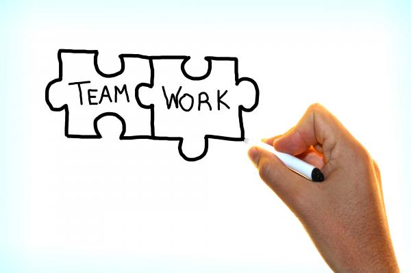 Hand writing the words Team Work on virtual screen
