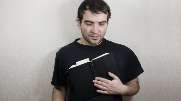 Handsome young man reading