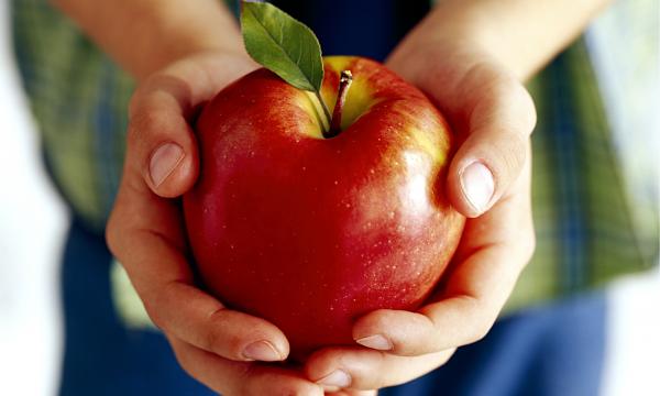 Holding an apple