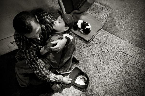 Homeless man with child and puppy
