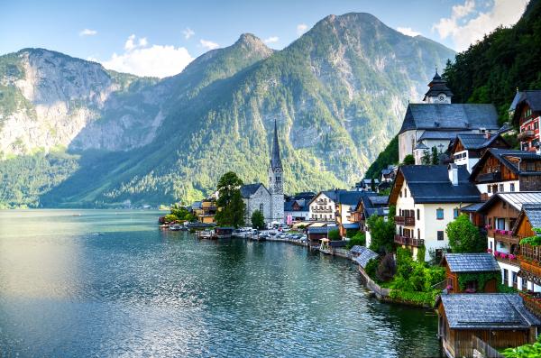 Houses Beside Body of Water and Mountains at Daytime