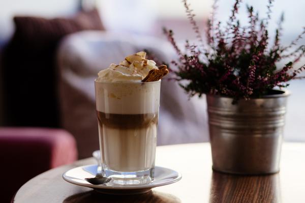 Ice Cream in Glass Beside Maroon Petaled Flower on Vase on Table