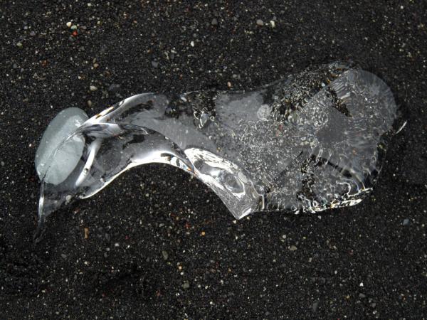Ice on black sand beach