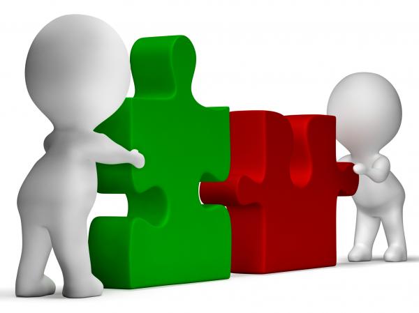 Jigsaw Pieces Being Joined Showing Teamwork And Collaboration
