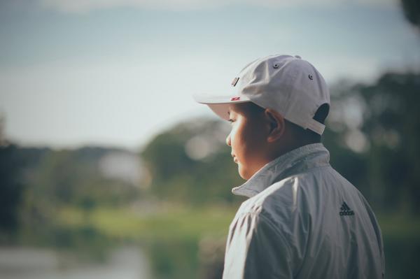 Kid Wearing White Cap and Adidas Jacket