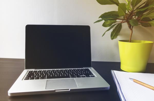Laptop and notebook on desk