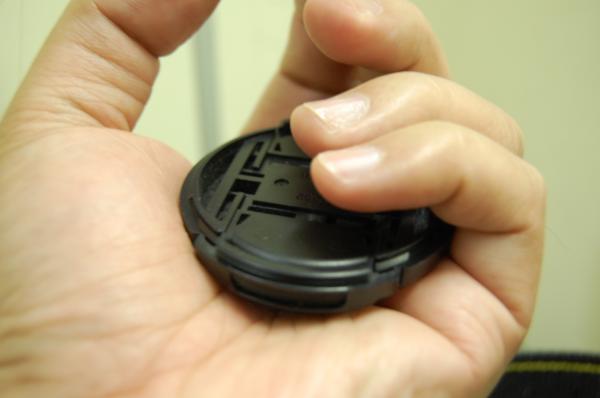 Lens cap in hand