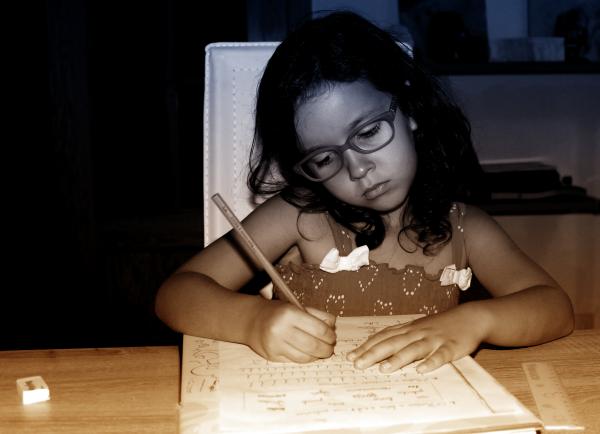 Little Girl Focused On Doing Homework