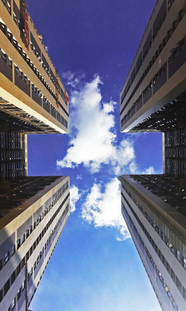 Low Angle View of Skyscraper Against Cloudy Sky