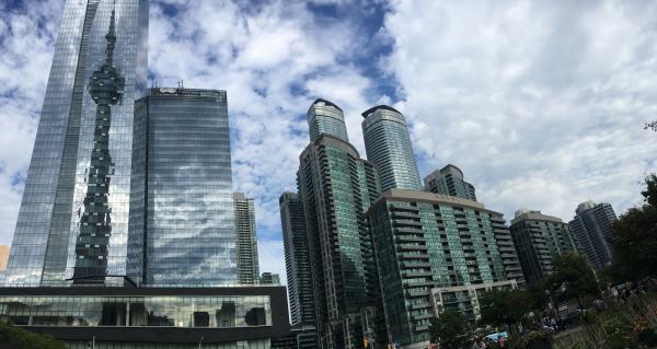 Low Angle View of Skyscrapers Against Cloudy Sky