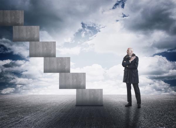 Man having doubts facing a staircase
