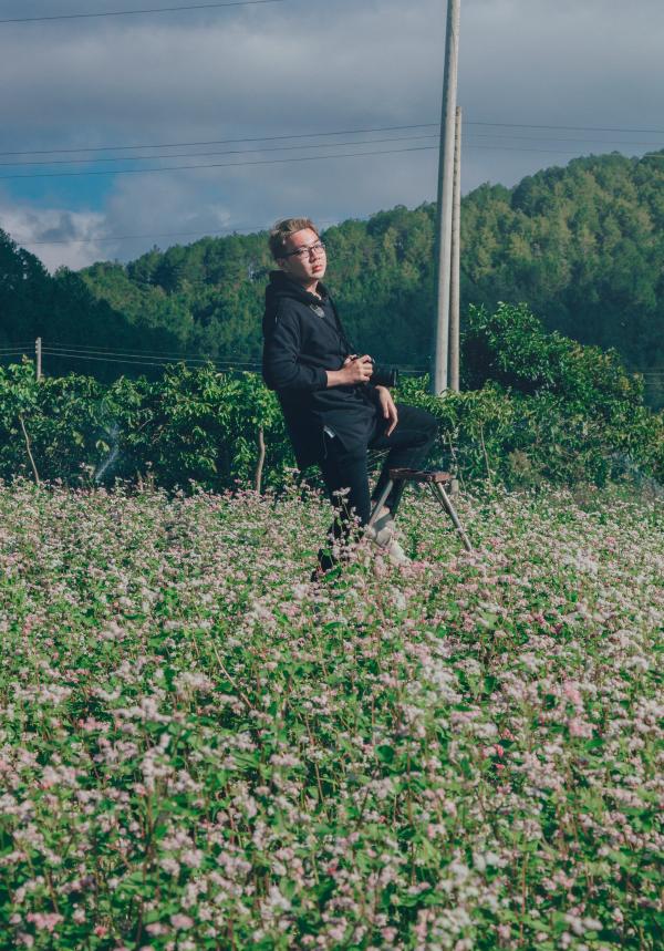 Man Holding Black Dslr Camera on Green Bush at Daytime