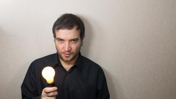 Man holding light bulb