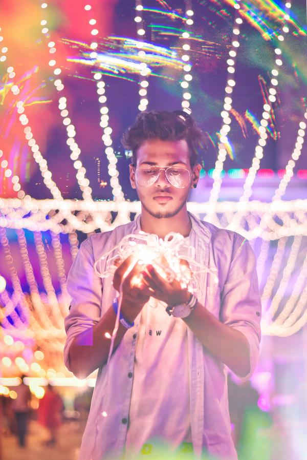 Man Holding String Light during Nighttime