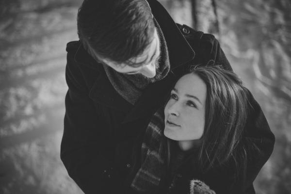 Man Hugging Smiling Woman from Behind