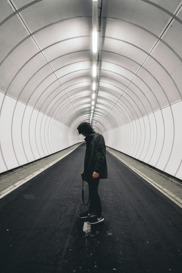 Man in Black Hoodie Standing Inside Panel