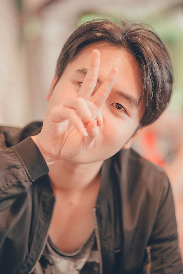 Man in Black Leather Zip-up Jacket Showing Peace Sign