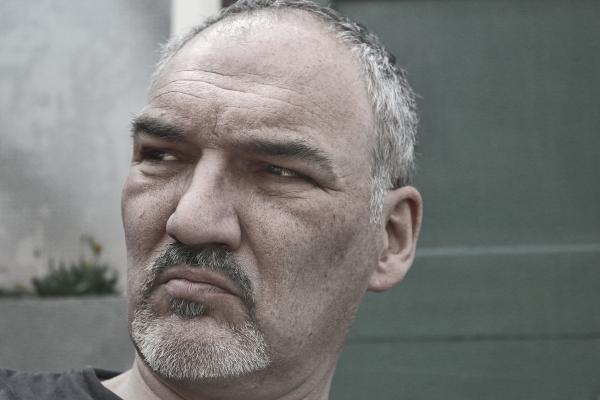 Man in Black Shirt Near Gray Wall