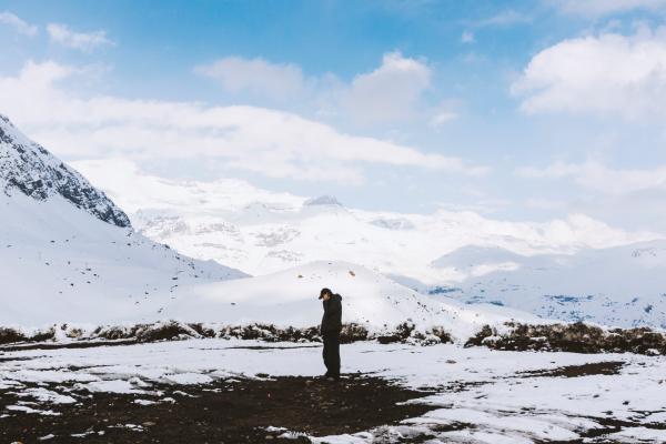 Man in Black Shirt Standing on White Snow Field