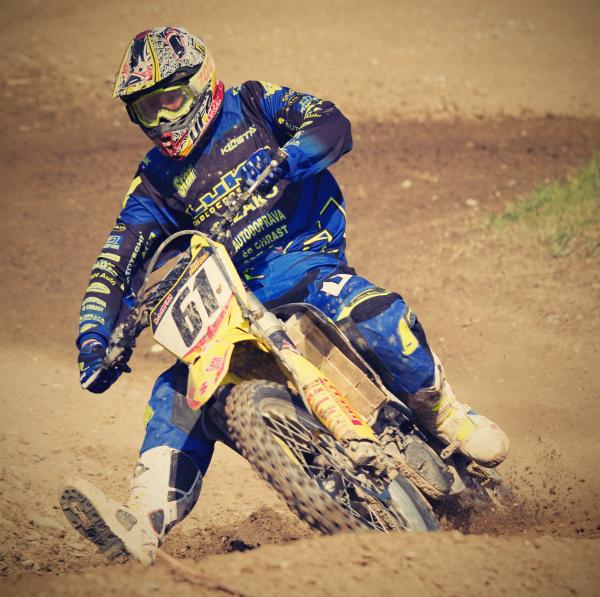 Man in Blue Motorcycle Suit Riding on Yellow Dirt Motorcycle during Daytime