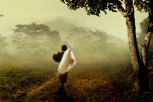 Man in Brown Robe Carrying White Fishing Net