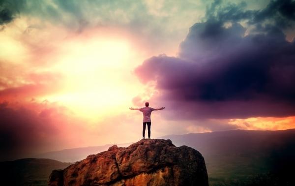 Man on the Summit Embracing a Brave New Day