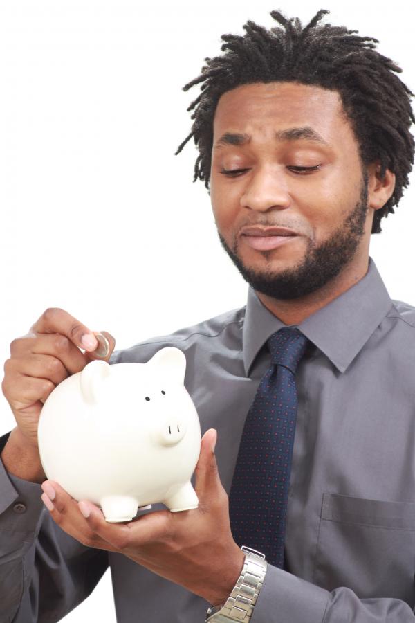 Man putting money into a piggy bank