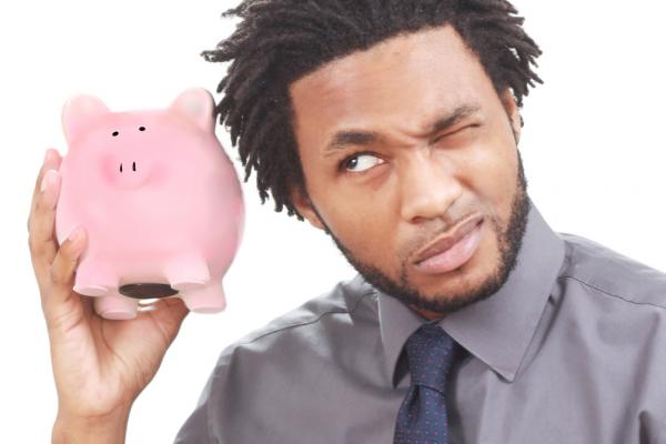 Man shaking a piggy bank